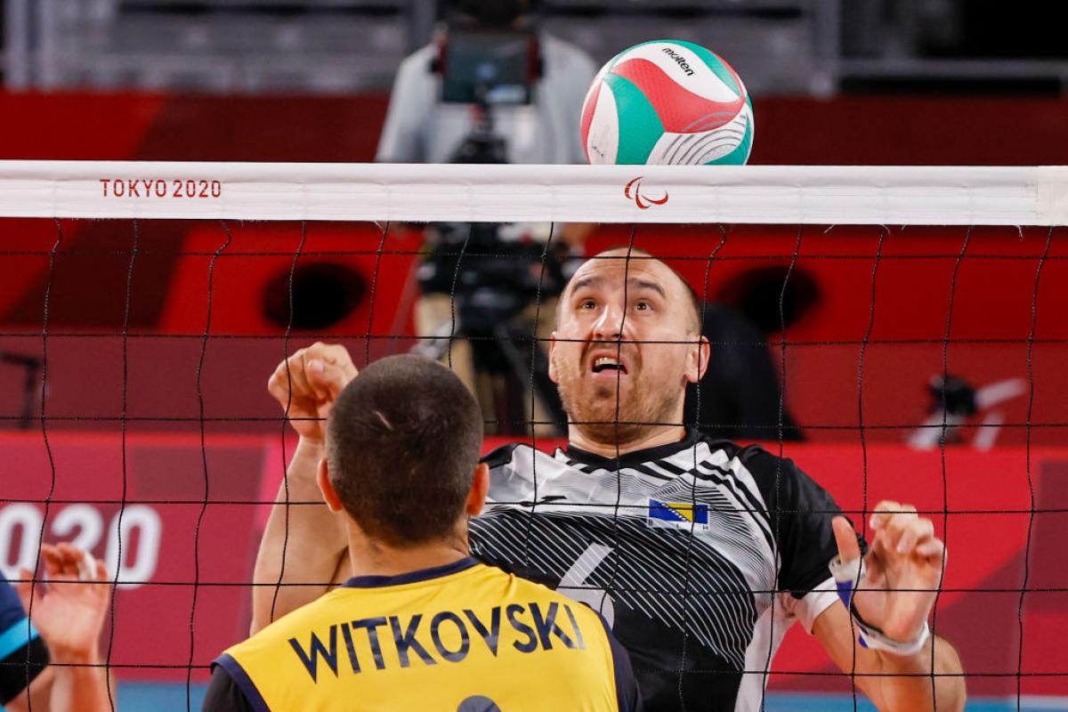 A male athlete reacts in front of the net